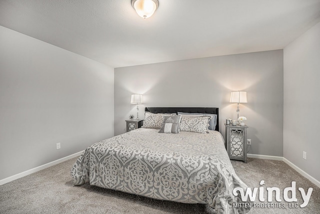 carpeted bedroom featuring baseboards