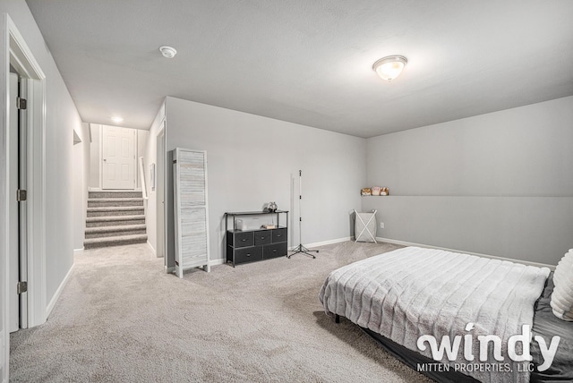 carpeted bedroom featuring baseboards