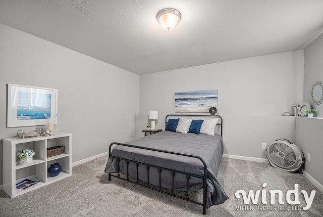 carpeted bedroom with baseboards and a textured ceiling