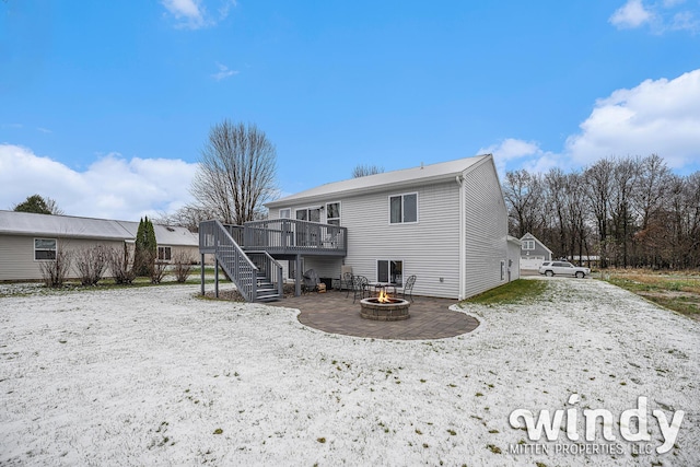 back of house featuring a deck, a patio, a fire pit, and stairs