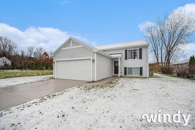 view of front of home with concrete driveway and an attached garage