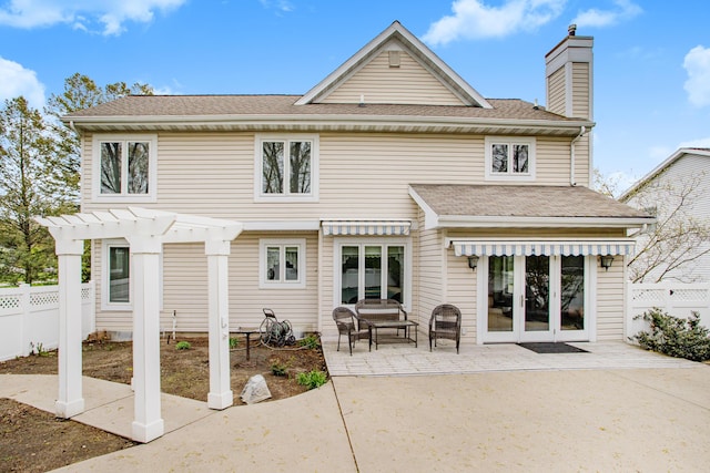 rear view of house featuring a patio, a chimney, roof with shingles, fence, and a pergola