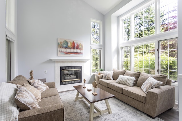 sunroom / solarium with lofted ceiling, plenty of natural light, and a fireplace