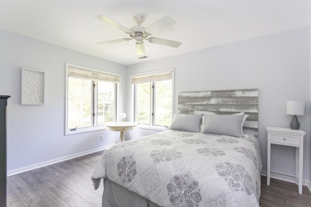 bedroom with visible vents, ceiling fan, baseboards, and wood finished floors