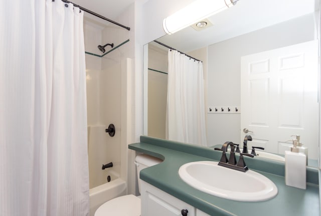 full bath featuring toilet, shower / bath combo, and vanity