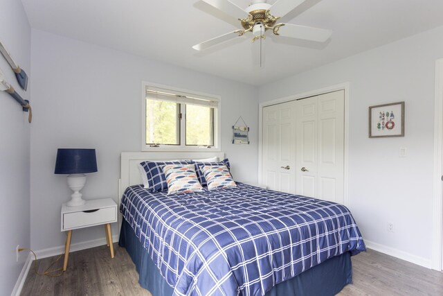 bedroom with ceiling fan, baseboards, a closet, and wood finished floors