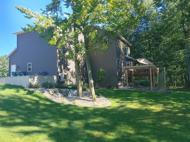 view of property exterior with a deck and a yard