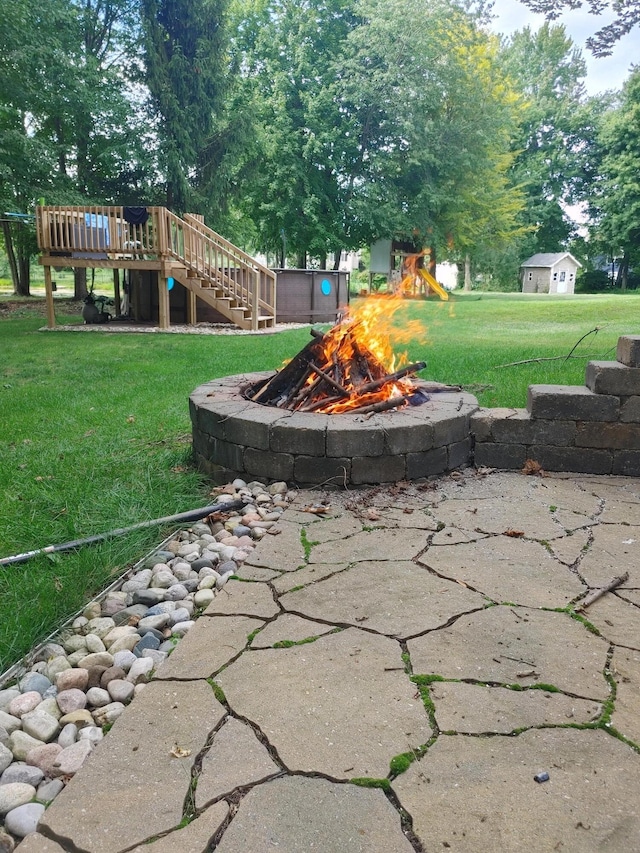 view of yard featuring a playground, a fire pit, and stairs