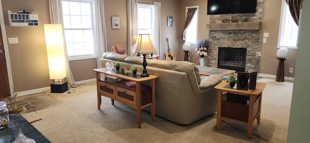 carpeted living area with a fireplace and baseboards