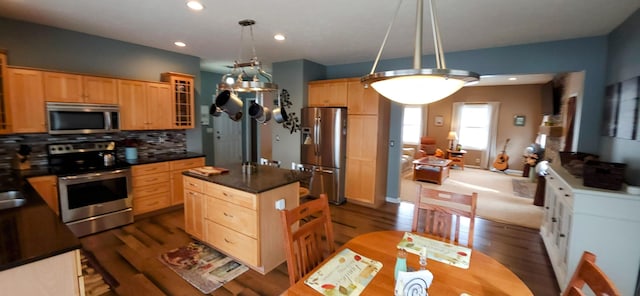 kitchen featuring stainless steel appliances, dark countertops, glass insert cabinets, and light brown cabinetry