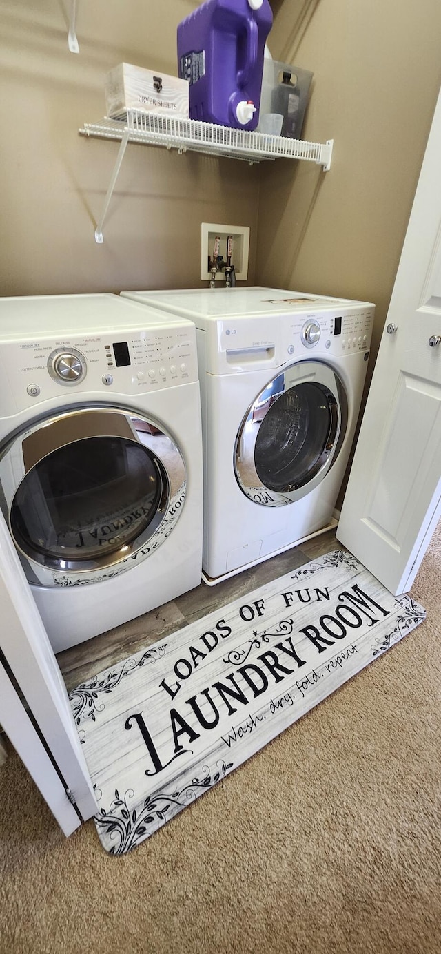 laundry room with laundry area, carpet flooring, and washer and dryer