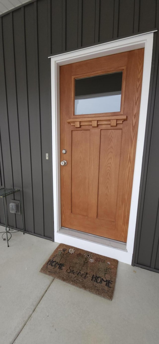 doorway to property featuring board and batten siding