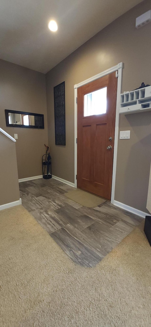 foyer entrance with recessed lighting, wood finished floors, and baseboards