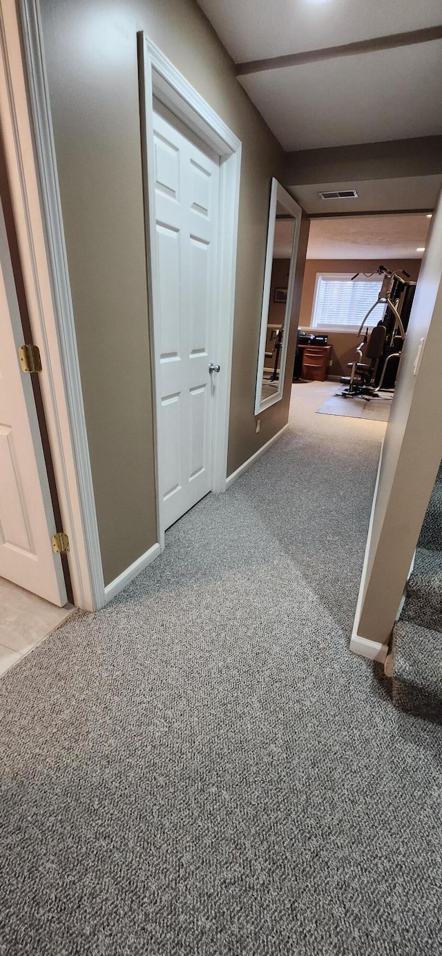 hall with carpet, stairway, and baseboards