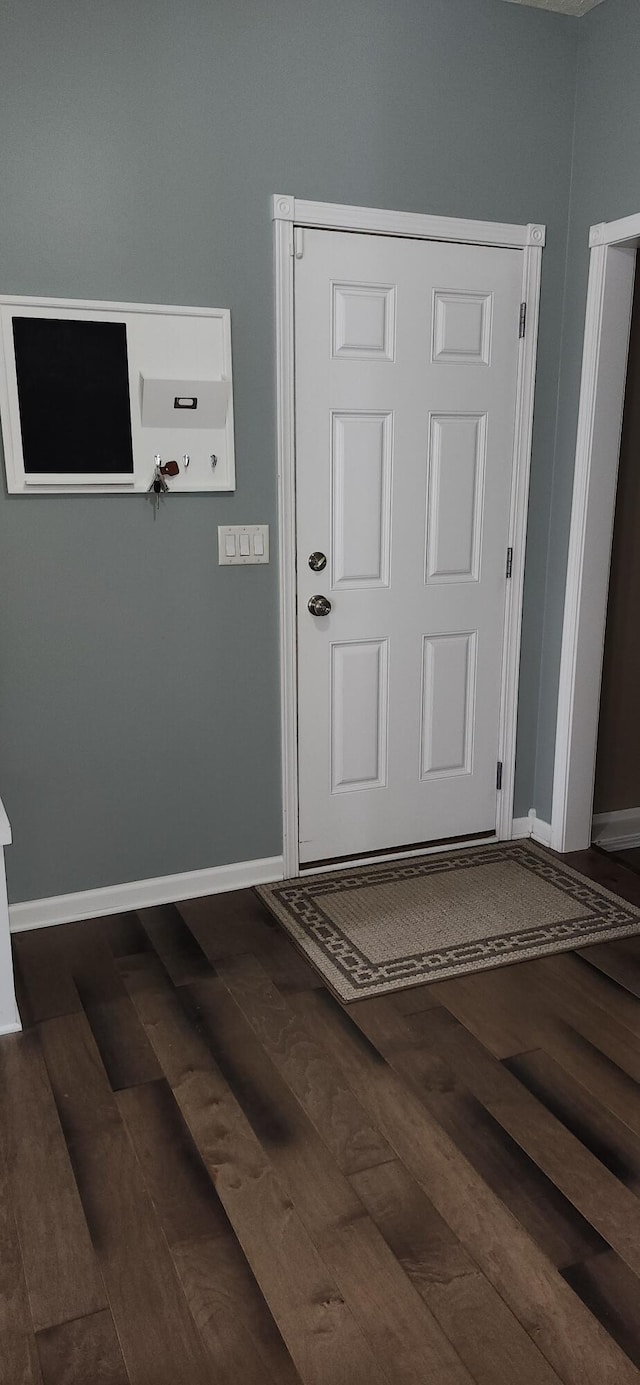 interior space with dark wood-style flooring and baseboards