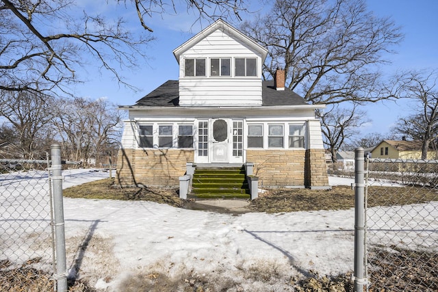 bungalow-style home featuring entry steps, stone siding, a chimney, and fence