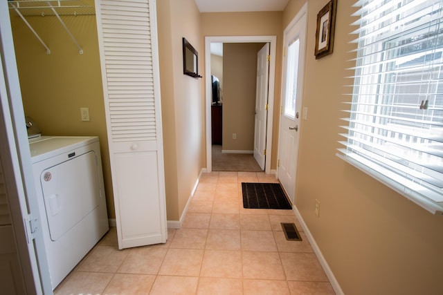 laundry area featuring light tile patterned floors, visible vents, washer / dryer, laundry area, and baseboards