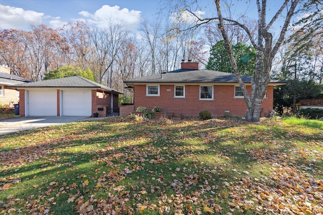 exterior space with a garage, brick siding, a chimney, and an outdoor structure