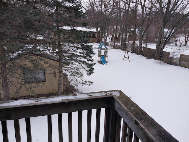 yard covered in snow featuring a balcony