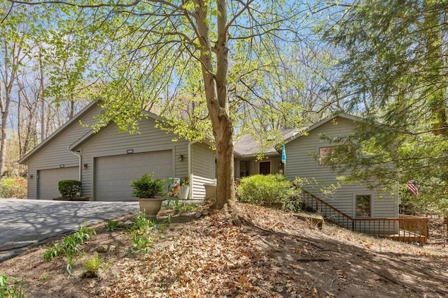 ranch-style house with a garage and concrete driveway