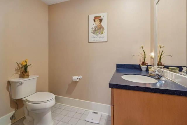 half bath with baseboards, vanity, toilet, and tile patterned floors