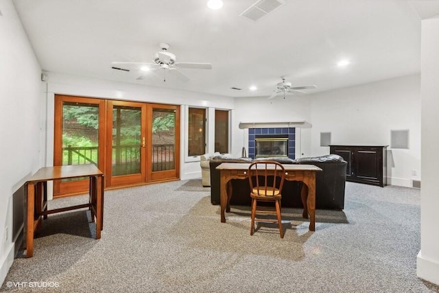 carpeted living room with recessed lighting, a tiled fireplace, visible vents, and a ceiling fan