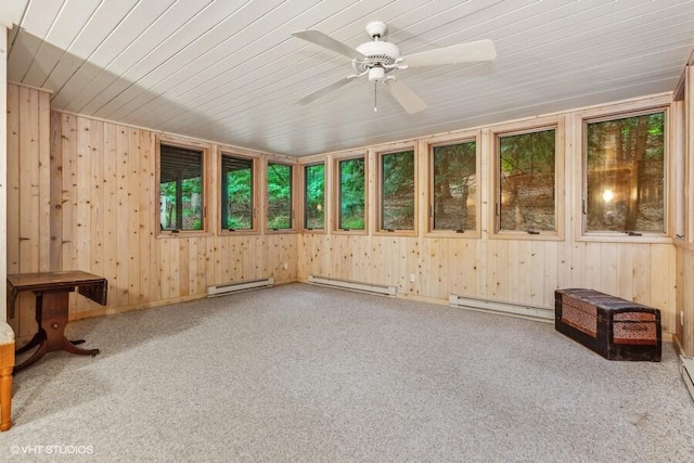 unfurnished sunroom with a baseboard heating unit, wooden ceiling, and a ceiling fan