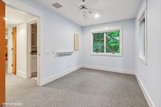 carpeted spare room with ceiling fan, visible vents, baseboards, and recessed lighting