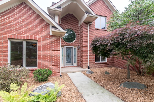 property entrance featuring brick siding