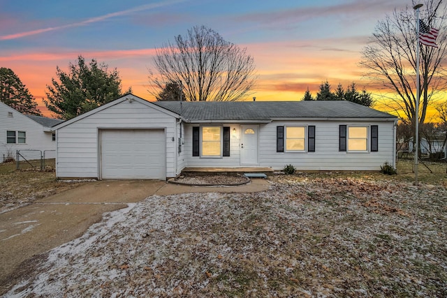 ranch-style home with a garage, concrete driveway, roof with shingles, and fence