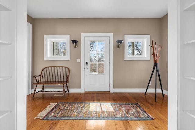 entrance foyer featuring wood-type flooring and baseboards