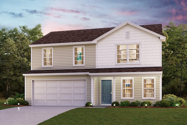 traditional-style home with a garage, concrete driveway, a yard, and a shingled roof