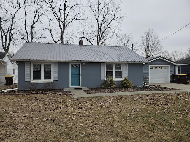 ranch-style house with a garage, driveway, a chimney, metal roof, and stucco siding