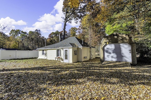 view of outbuilding featuring an outbuilding and fence