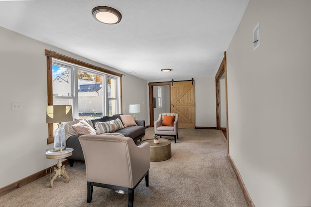 carpeted living room with a barn door and baseboards