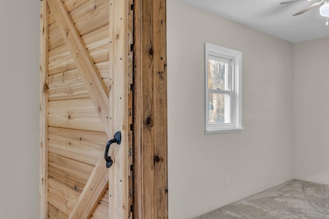 interior details with carpet and a ceiling fan