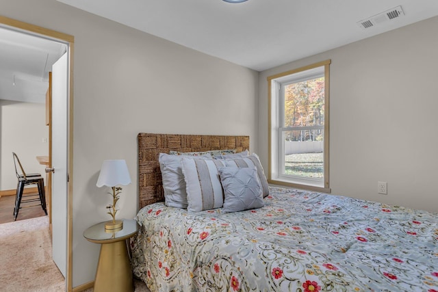 carpeted bedroom featuring visible vents