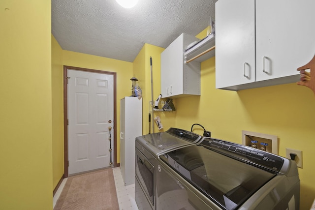 washroom featuring light floors, cabinet space, a textured ceiling, washer and dryer, and baseboards