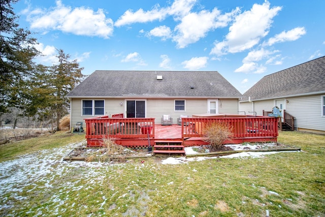 back of house featuring a yard, roof with shingles, and a wooden deck