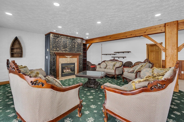 carpeted living room with a tile fireplace, a textured ceiling, and recessed lighting