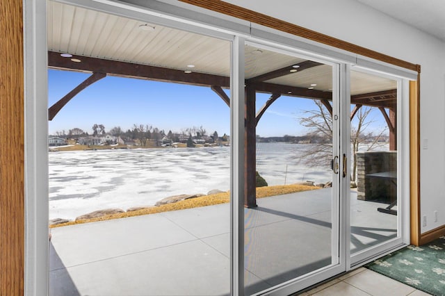 doorway to outside with tile patterned flooring