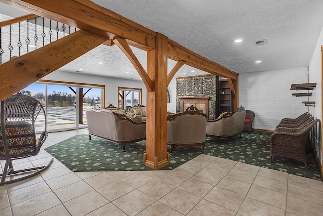 living room featuring visible vents, tile patterned flooring, a textured ceiling, beam ceiling, and recessed lighting