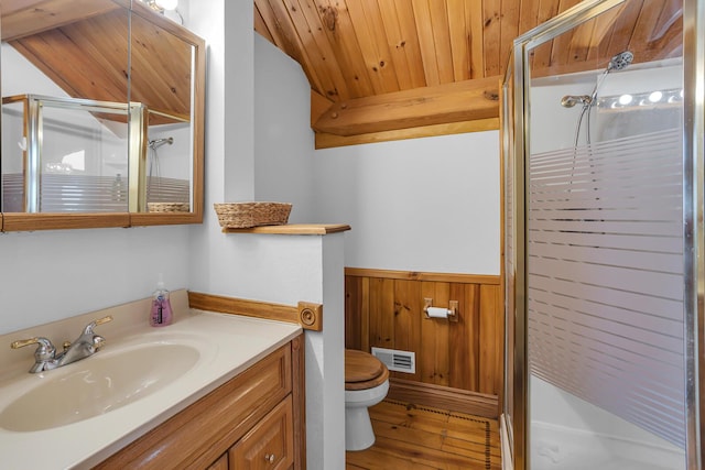 bathroom with wainscoting, wooden ceiling, a shower stall, and wooden walls