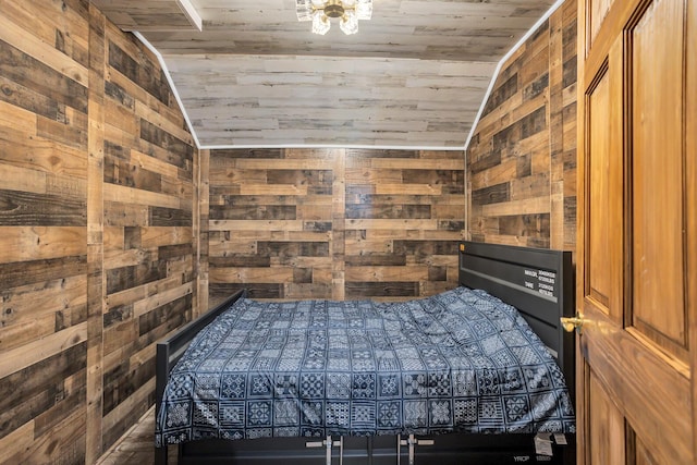 bedroom featuring wooden ceiling, vaulted ceiling, and wood walls