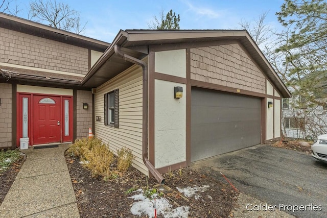 exterior space featuring a garage and aphalt driveway