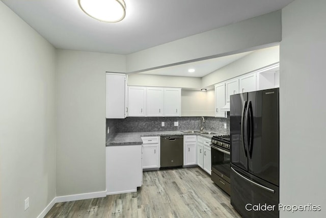 kitchen featuring stainless steel appliances, white cabinetry, and decorative backsplash