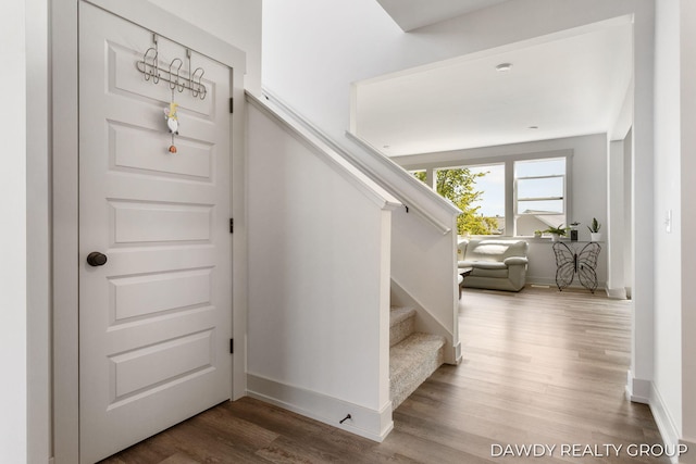 stairway featuring wood finished floors and baseboards