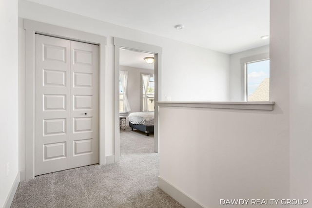 corridor featuring carpet and baseboards