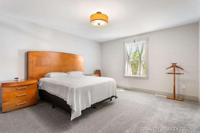 bedroom with carpet flooring and baseboards