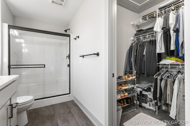 full bathroom with a stall shower, visible vents, a spacious closet, and toilet